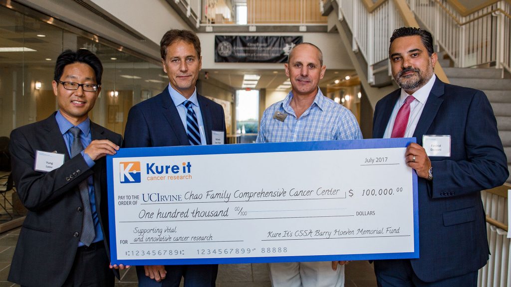 Kure It Cancer Research Donors Holding Check